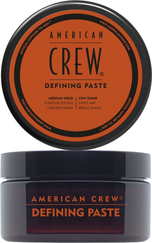 A round orange and black container label at the top, and a grey jar of hair styling paste shown below.