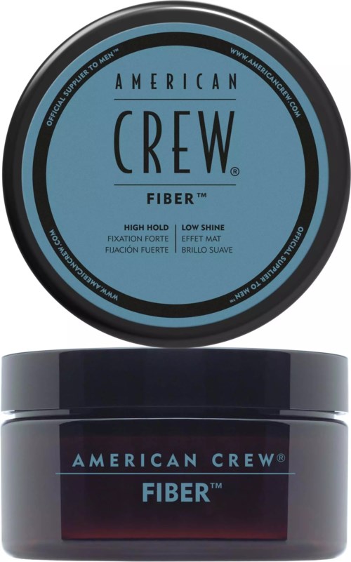 En rund blå og svart beholder av American Crew Fiber hårprodukt med en mørk krukke under.