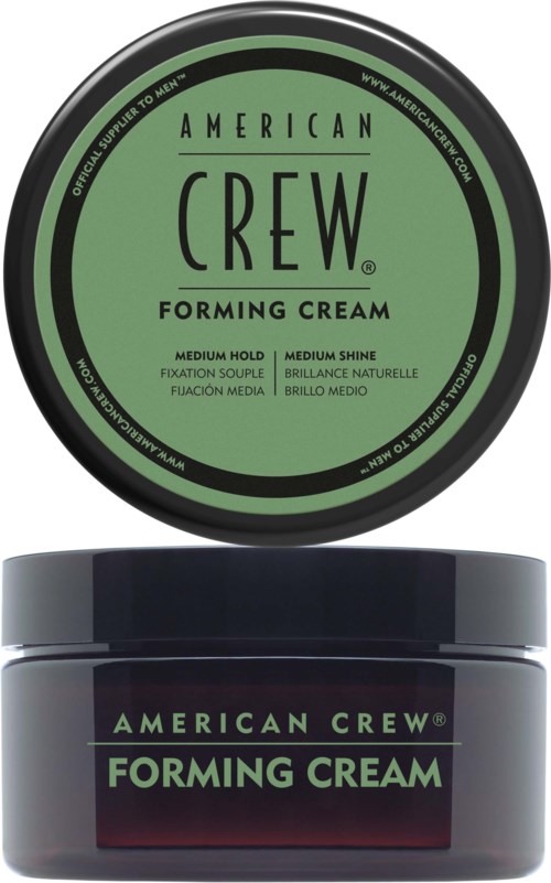 A round green label for American Crew Forming Cream on a dark container. The label mentions medium hold and shine.