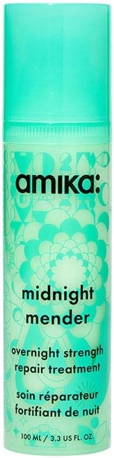 A blue-green bottle labeled 'Amika midnight mender' with floral designs, for overnight hair repair treatment.