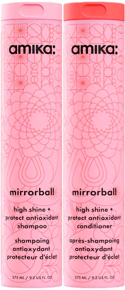 Vaaleanpunaiset Amika mirrorball -shampoo ja hoitoainepullot, joissa kukkakuviot ja tuotetiedot.