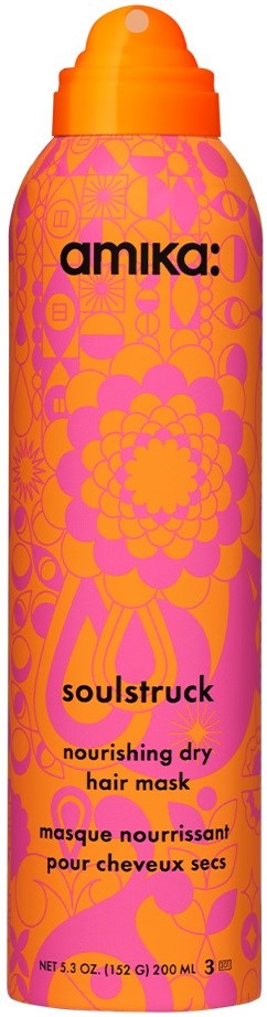 A tall pink bottle with orange cap, decorated with floral and leaf patterns, labeled as nourishing dry hair mask.