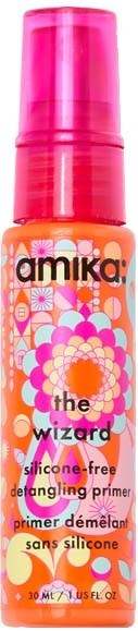 A small spray bottle with colorful floral and geometric patterns, labeled as a silicone-free detangling primer.