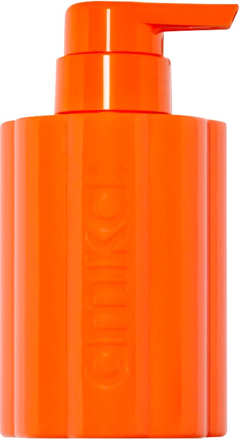 An orange bottle with a pump, likely for lotion or soap, standing upright against a white background.