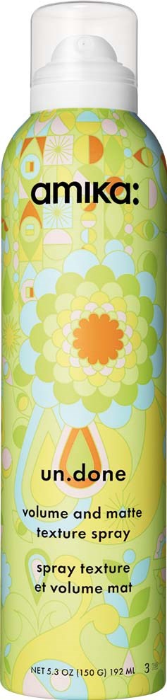 Bright yellow and green floral design bottle with black and orange text for volume and matte spray.