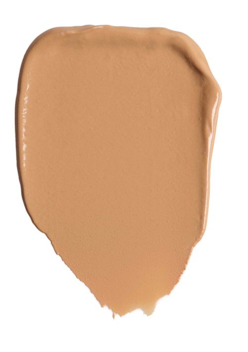 Ein beiger Fleck Make-up oder Foundation auf weißem Hintergrund.