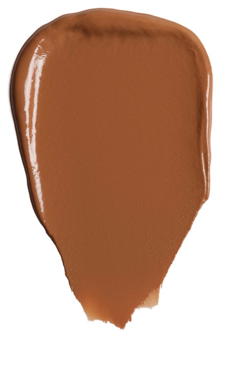 Braune Flüssigkeit auf weißer Fläche, geformt wie ein Blatt.