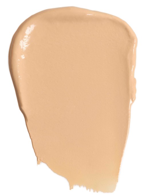 Een beige gekleurde vloeistof of crème uitgesmeerd op een witte achtergrond.