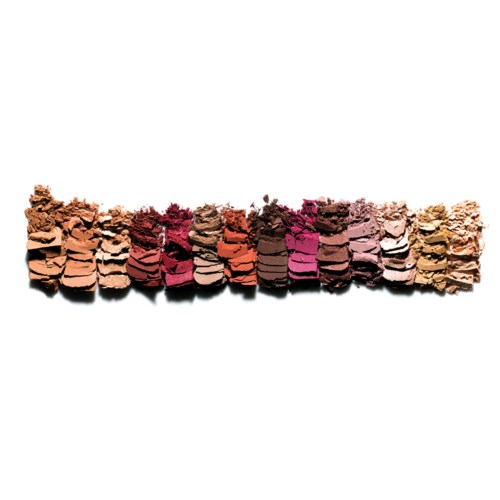 Colorful crushed makeup powders arranged in a line on a white background.