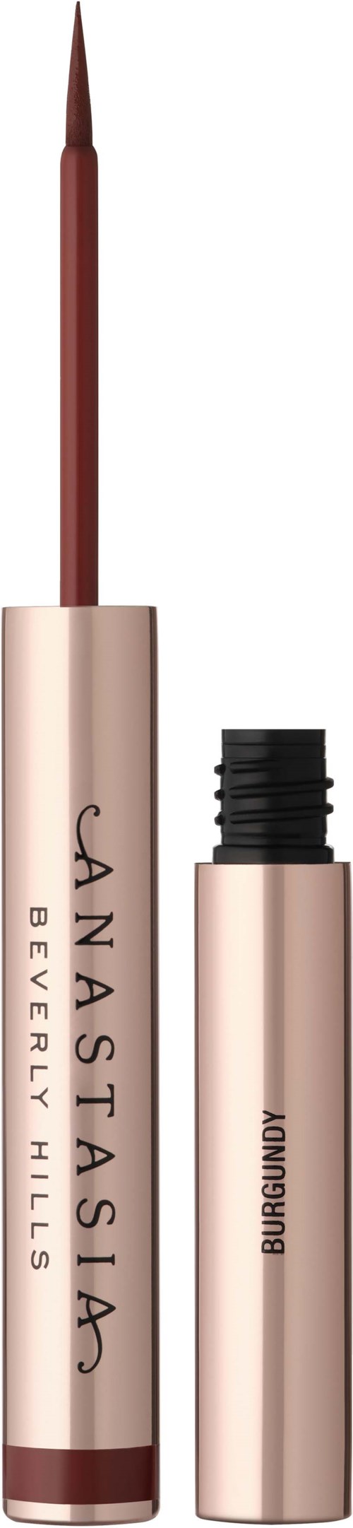 Ein Lippenstift mit Pinselapplikator und separatem Deckel, goldfarben mit schwarzem Text, vor schwarz-weißem Hintergrund.