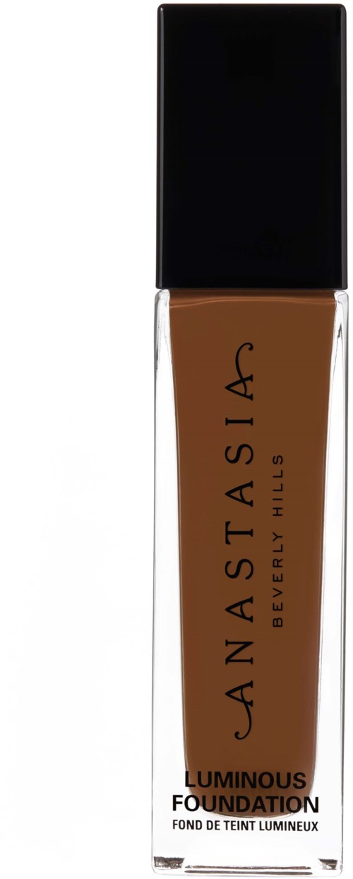En flaska av Natasha Denona Luminous Foundation i brunt med svart lock.