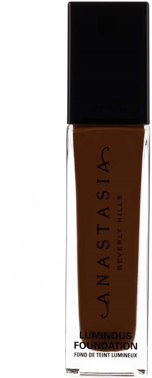 Sävyttävä kasvomeikkivoidepullon, jossa on musta kansi ja ruskea neste. Tekstissä lukee Anastasia Beverly Hills Luminous Foundation.