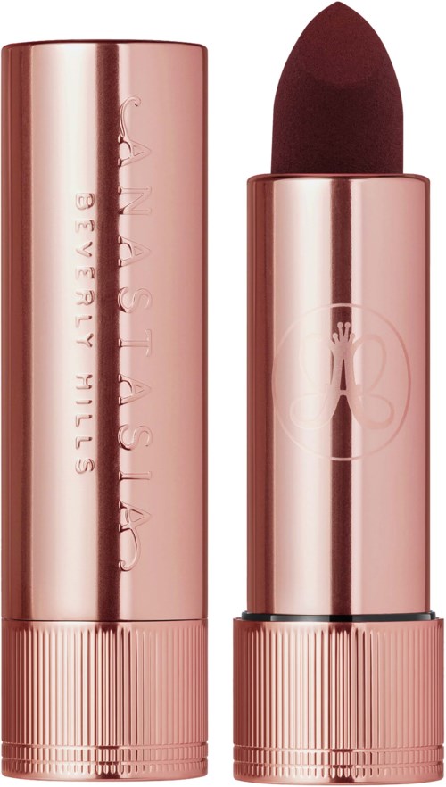 Rose gold lipstick in a matching tube, with a dark red color, and cute cartoon girl illustration on the tube.