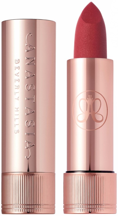 A pink lipstick in a shiny tube, with the lid off, revealing the lipstick. The tube has the brand name 'Canastasia' on it.