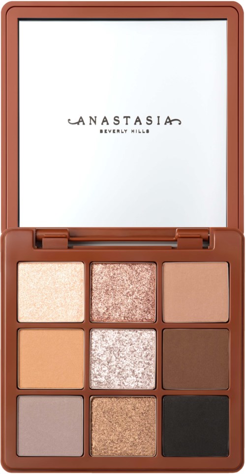 A makeup palette with nine different shades, including neutral, shimmer, and darker colors, in a brown case.