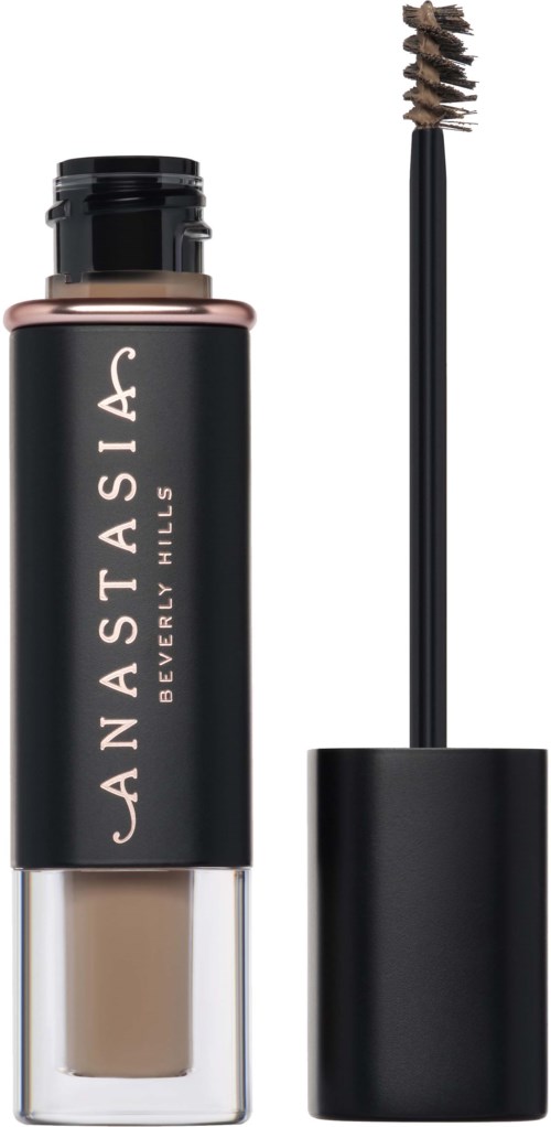 Een fles concealer met applicator ernaast. De fles is zwart en goud, van NARSIS. Beverly Hills is erop geschreven.