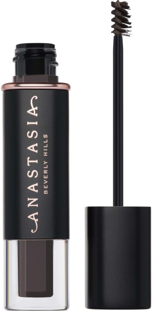 A black cylindrical tube with a clear bottom, labeled 'Anastasia Beverly Hills', and an attached makeup brush.