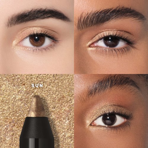 Close-up of two eyes with gold eyeshadow, makeup swatches, and a gold eyeshadow stick on a textured background.