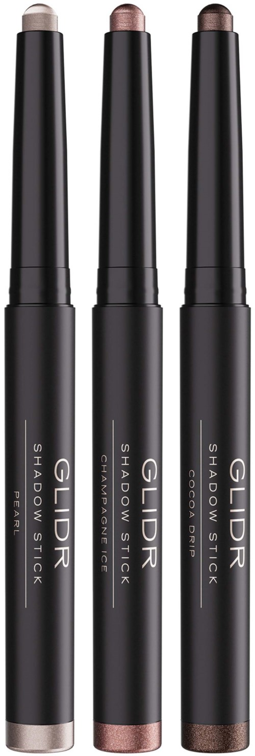Three Gildr Shadow Stick makeup sticks in black packaging, with bronze, rose gold, and brown shades visible.
