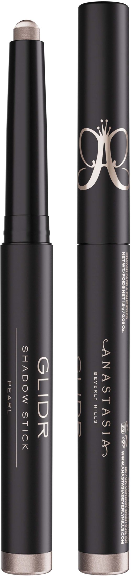 Two black makeup sticks, labeled GldR Shadow Stick and Jan Taisim, with silver accents, stand vertically against a black background.