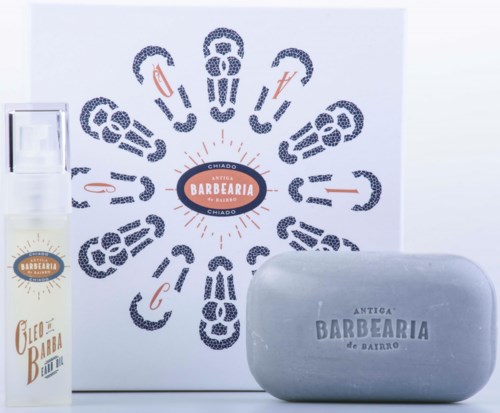 A wall design with various barber tools and symbols arranged around a central logo, a soap bar, and a product bottle.