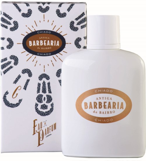 A white bottle with a label and a decorative box behind it, both promoting a cologne called 'Barbearia'.