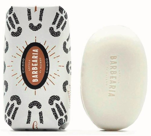 A soap bar with the words "Bartbeira" on it and blotted by a package with black paw prints.