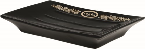 A black rectangular dish with gold decorative writing and logos on it.