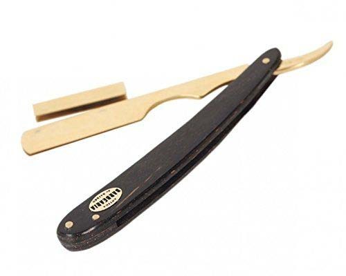 A straight razor with a black handle, blade folded in, and a small wooden spatula-like tool.