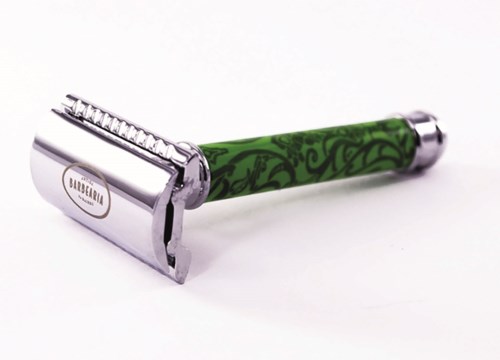 A safety razor with a green handle and silver head, placed on a white surface.