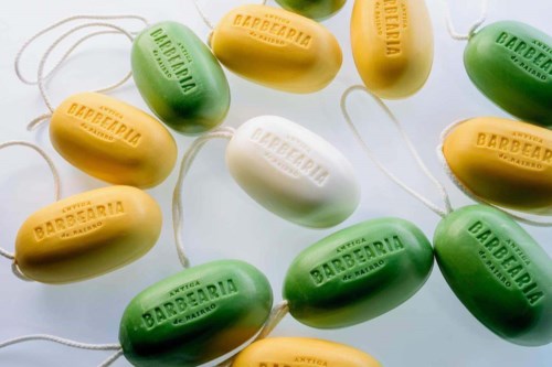 Colorful soap bars in yellow, green, and white with a string, labeled "Barberia" and "Arreglo".