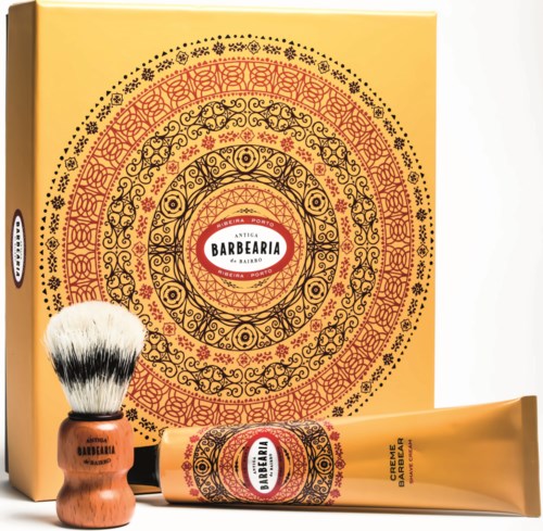 A beige and red set with decorative patterns, including a brush and tube labeled 'Antiga Barbearia' for shaving.