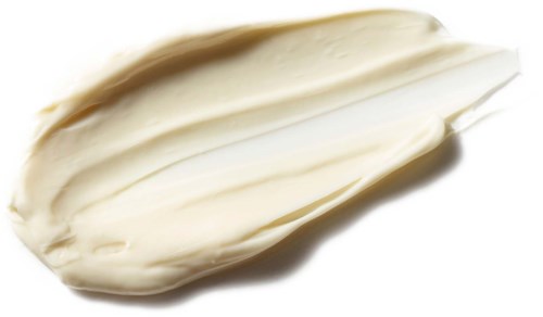 En vit, lång och slät föremål som ser ut som en grönsak eller frö med spetsig ände.