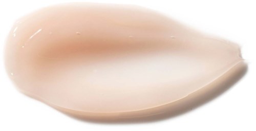 Ett beige, slätt, kurvigt föremål med ytskikt som är glänsande, kanske en skal eller konstverk.