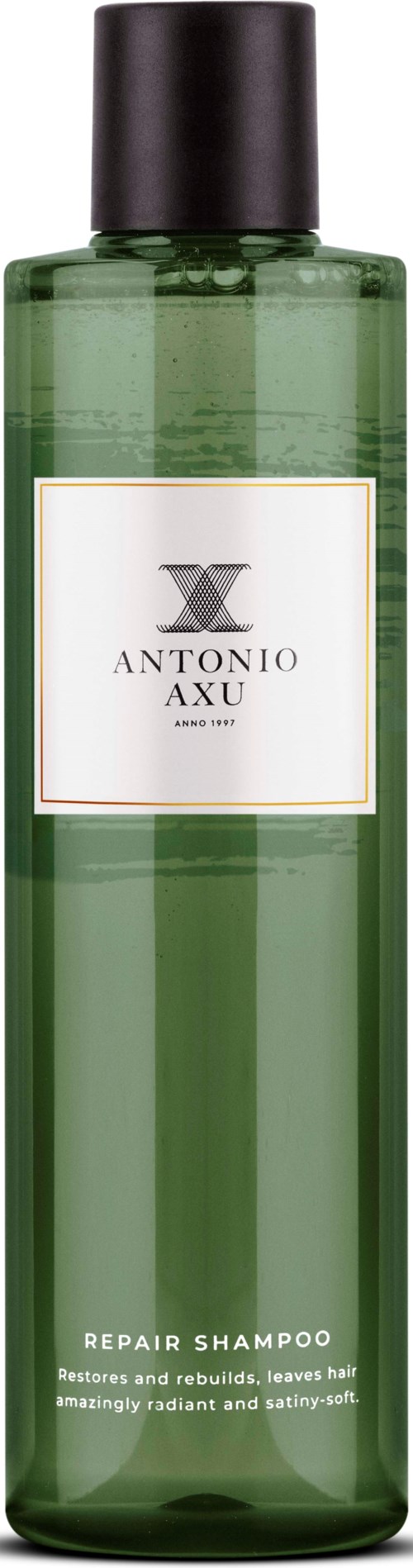 Groene fles met Antonio Axu Repair Shampoo met zwarte dop, etiket toont merk en productnaam.