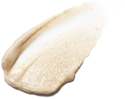 Creamy beige skincare product with a smooth, thick texture and small brown particles.
