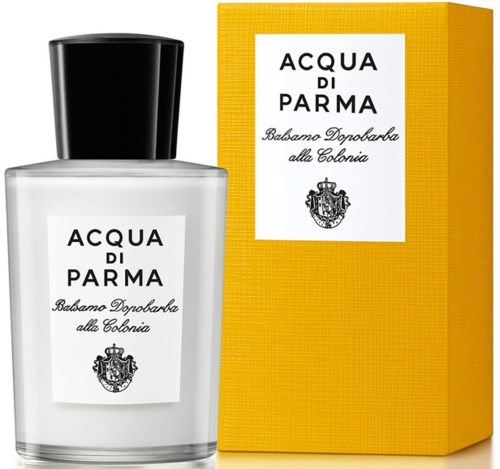 A white perfume bottle with a black cap next to a yellow box with a white label and text.