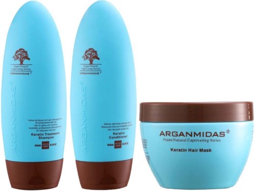 Drei blaue Haarpflegeprodukte mit braunen Verschlüssen: Shampoo, Conditioner und Haarkur von Argannidas.