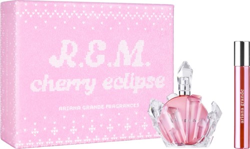 A pink box labeled R.G.M cherry eclipse with white text, a crystal-shaped perfume bottle, and a lip gloss tube.