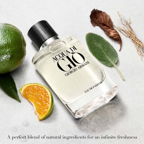 A perfume bottle with lemon and orange slices, leaves, and dried flowers around it.