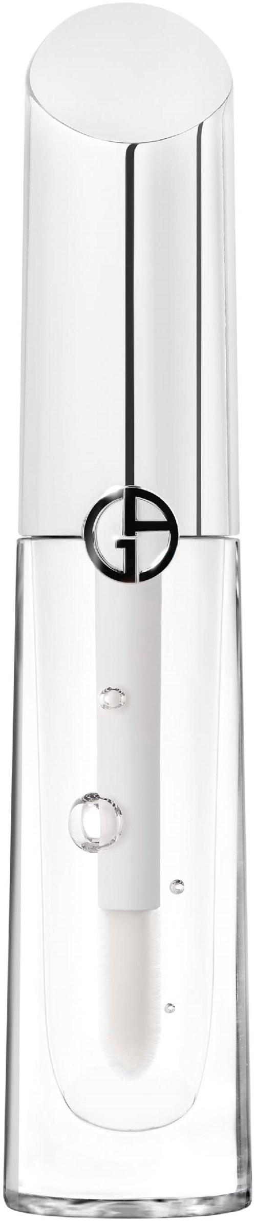 A clear, tall glass container with a black logo and a small white stick inside. It appears to be a cosmetic product.