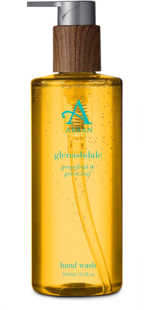 Eine klare gelbe Handwaschflasche mit Holzdeckel und blauer Schrift, Logo mit Baum-Symbol.
