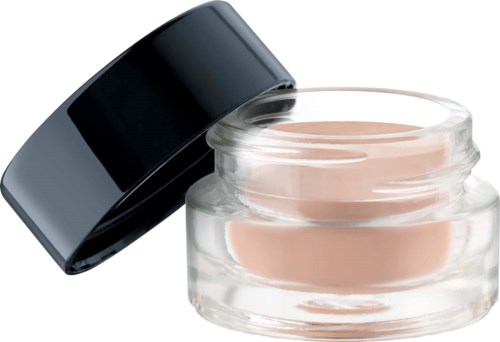 Glasburk med ljus beige kräm och svart lock ovanpå.