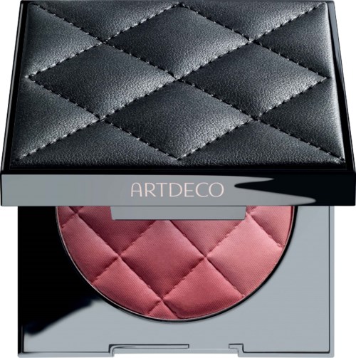 A compact makeup blush with a quilted design, black lid, pink blush, and a mirror inside.