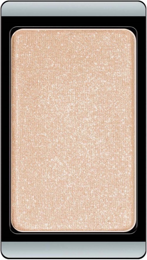 En skimrande beige highlighter med strukturerad yta i en svart makeup-kompakt.