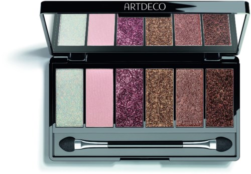 A makeup palette with six glittery and matte eyeshadows in pastel and dark shades, with an applicator placed inside.