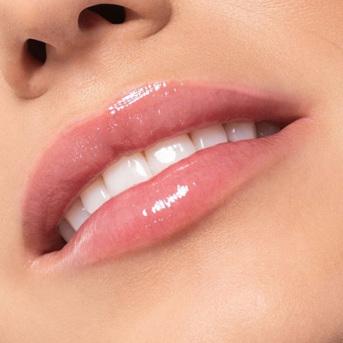 Nahaufnahme der Lippen einer Person, leicht geöffnet, zeigt weiße Zähne und glänzende Haut.