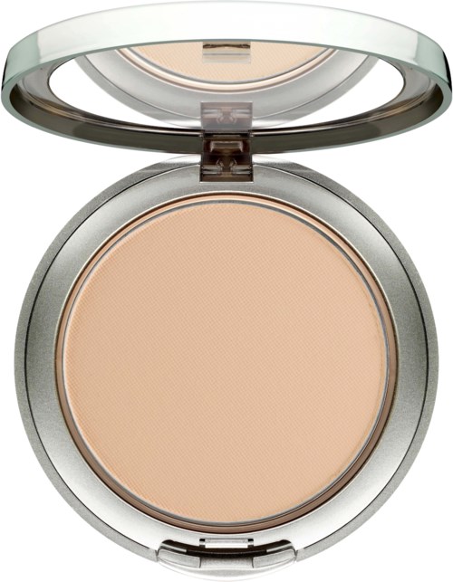 A round compact with beige powder inside, a transparent lid, and silver edges.