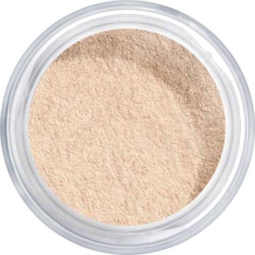 Pyöreä säiliö, jossa vaale beige irtopuuteri sisällä.