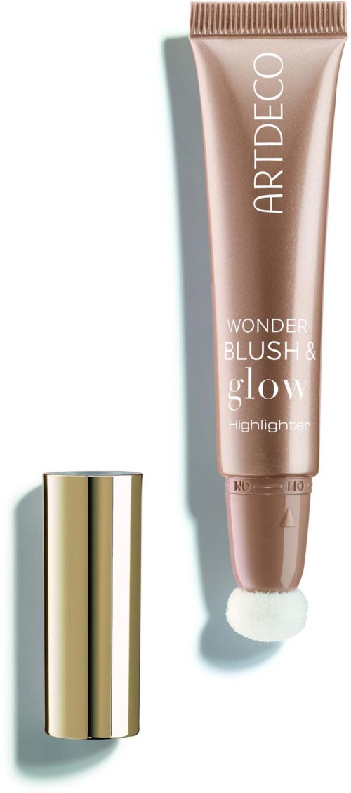 Een make-upproduct met een gouden dop en een lichtroze lichaam, gelabeld Wonder Blush & Glow, met een sponsapplicator.